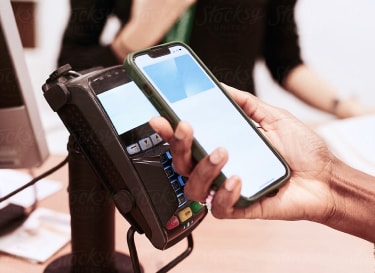 A person making contactless payment with mobile
