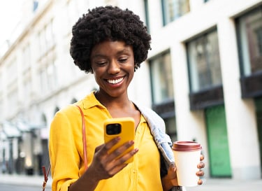 A women with yellow t-shirt using phone